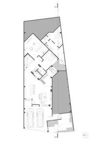 Floor plan of a residential space with concrete finishes and tiled areas.