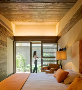 A modern bedroom suite featuring wood elements and natural light.
