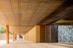 Modern architectural interior space made from wood with blue and white tiled wall and a horse model.