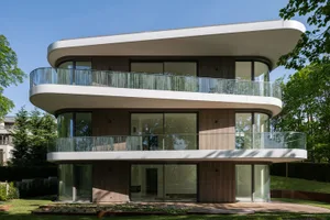 A modern house with wooden cladding and large glass windows.