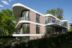 A modern residential building featuring wood and glass materials.