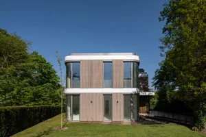 Modern residential building with wood siding and large glass windows
