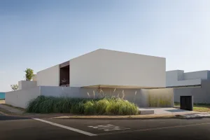 Modern building with a minimalist design featuring concrete materials.