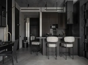 Contemporary kitchen featuring a grey concrete countertop with three upholstered bar stools.