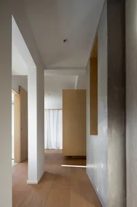 Modern minimalist hallway with wooden flooring and plaster walls