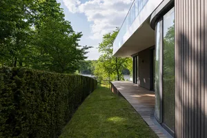 Modern residential exterior with wood siding and concrete facade