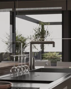 Modern interior kitchen with metallic faucet and glasses.