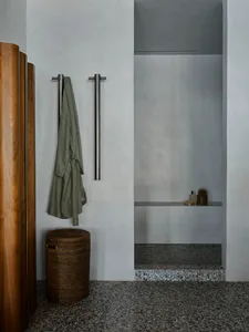 Modern shower room with terrazzo flooring and minimalist design.