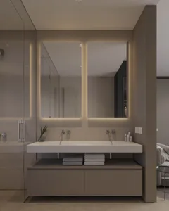 Modern bathroom features tiled walls, glass shower enclosure, and metal accents.