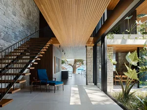Modern interior space featuring concrete walls and a wooden ceiling.