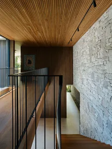 A modern interior with a wooden staircase and terraced walls.