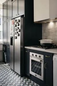 Modern kitchen featuring dark wooden cabinets and stainless steel appliances