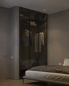 A modern minimalist bedroom with a bed, wardrobe, and natural lighting.