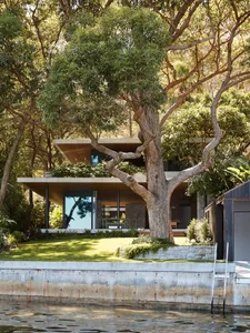 A modern residential exterior featuring concrete and glass materials.