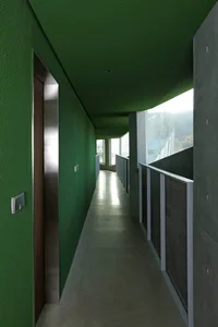 Concrete hallway with green walls and ceiling