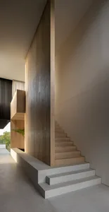 Modern wooden and concrete stairs in a minimalist interior design.