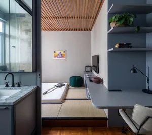 A minimalist bedroom featuring wood paneling, glass windows, and a tatami floor.