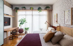 A minimalist bedroom featuring wooden furniture and textiles, with a large window allowing natural light.