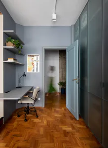 Modern minimalist home office with a wood floor and minimalist furniture