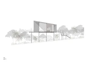 A modern house with a metal exterior and large glass windows.