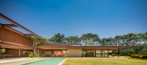 A modern house featuring wooden beams and glass walls.