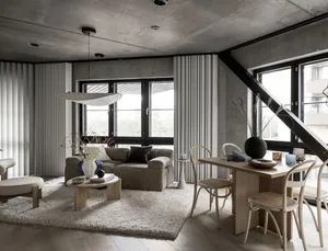 A modern living and dining room with minimalist decor, concrete ceiling, wooden furniture, fabric accents, and large windows 