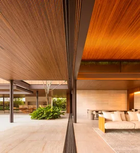 Modern living room with wooden beams, concrete floor, and indoor plant