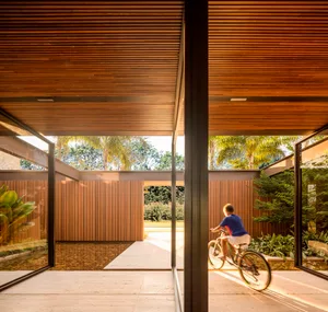 A modern residential interior featuring wooden materials and a spacious, open-concept design.