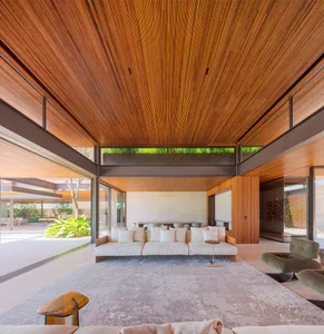 A modern residential living room featuring concrete floor tiles and minimalist furniture.