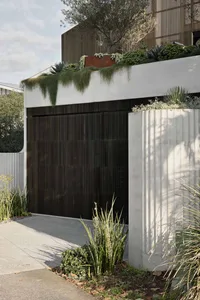 Modern house exterior with concrete walls and vehicle garage.