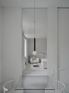 Minimalist dining room with a glass floor and wall.