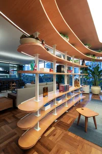 A modern living room featuring wooden shelves and furniture.