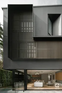 A modern residential architecture with a metal screen facade
