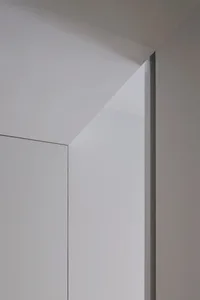 A minimalist door frame with metallic edges against a white background.