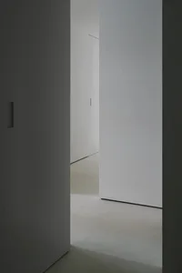 A minimalist interior with concrete walls and flooring.