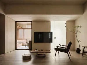 Minimalist living room with wooden floor, glass wall, and concrete structure