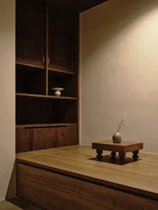 A minimalist office space featuring wooden furniture and decor.
