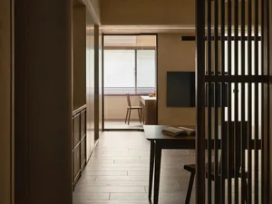Home office featuring modern, wooden furnishings with a sleek desk and minimalist decor.