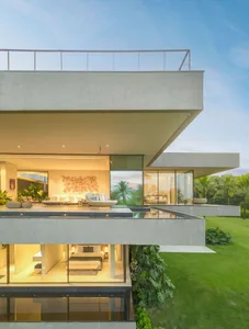 A modern residential extension with a concrete facade and large glass windows.