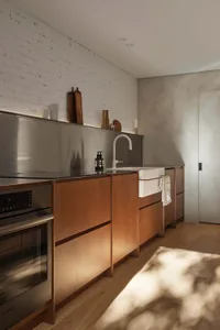 Modern residential kitchen featuring wooden cabinets and a stainless steel oven.