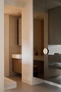 Minimalist modern bathroom with sleek white tiles and wooden vanity