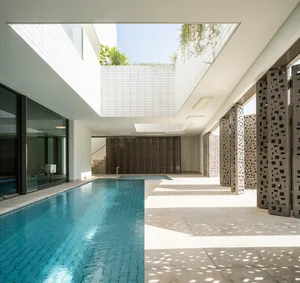 Modern residential space featuring glass walls and concrete flooring.
