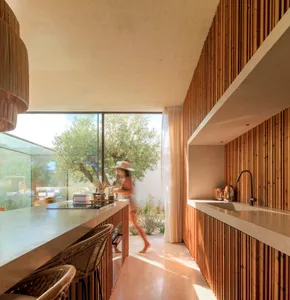 Modern residential kitchen featuring wood and concrete materials.
