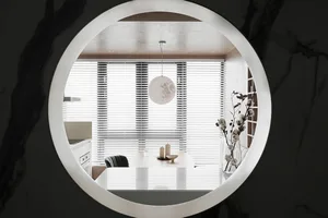 Modern, minimalist residential dining room with white decor and white pendant light hanging from the ceiling.