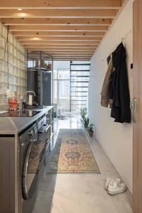 Industrial-style apartment entrance featuring concrete flooring and minimalist decor.