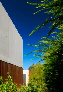 Modern building exterior featuring concrete and wooden surfaces.