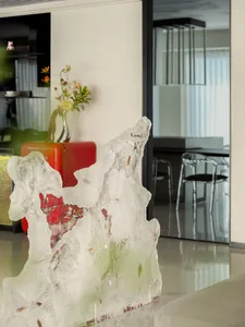 Modern living room with a crystal ice sculpture and red refrigerator.