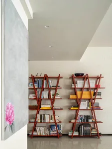 Modern interior design featuring a shelving unit filled with books, placed in a room with a minimalist design aesthetic.