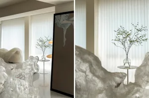 Modern living room with glass walls and minimalistic decor.