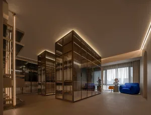 Modern interior design featuring glass, metal, and fabric elements.